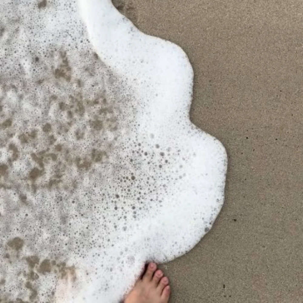 Sea foam on sand