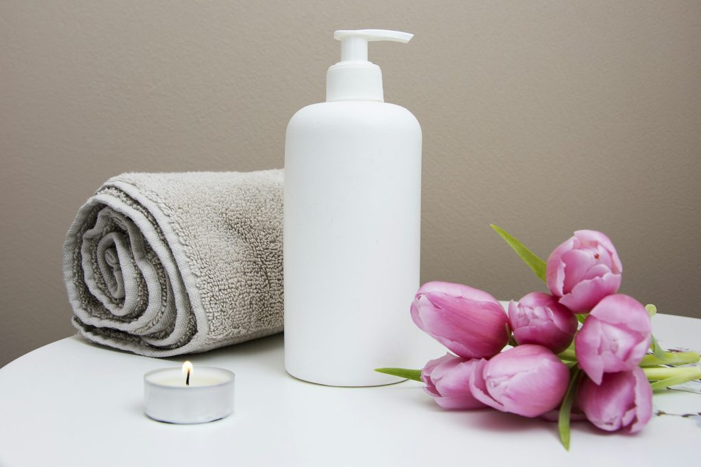 Spa massage oil and fresh flowers